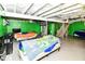 Unfinished basement with green accent walls and a ladder at 3302 N Gladstone Ave, Indianapolis, IN 46218