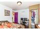 Bedroom featuring purple accent door, small desk, and closet at 3302 N Gladstone Ave, Indianapolis, IN 46218