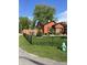 Charming house featuring wood fencing, lush green lawn, beautiful landscaping, and a vibrant green fire hydrant at 3302 N Gladstone Ave, Indianapolis, IN 46218