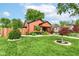 Beautiful landscaped yard with mature trees surrounding the charming single Gathering home at 3302 N Gladstone Ave, Indianapolis, IN 46218