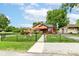 A quaint home featuring a well-manicured front yard, privacy fence and mature landscaping at 3302 N Gladstone Ave, Indianapolis, IN 46218
