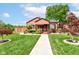 Charming home featuring manicured lawn, landscaping, and a welcoming walkway to the covered front porch at 3302 N Gladstone Ave, Indianapolis, IN 46218