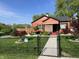 Charming single-story home featuring a well-manicured lawn, secure black fencing, and lovely landscaped garden at 3302 N Gladstone Ave, Indianapolis, IN 46218