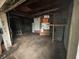 Large garage space with exposed ceilings, shelving, and potential for workshop or storage at 350 Johnson Ave, Franklin, IN 46131
