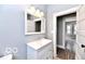 Modern bathroom with a sleek vanity, mirror, and fixtures at 36 N Ewing St, Indianapolis, IN 46201