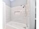 Elegant bathroom featuring tiled walls, a soaking tub and a modern shower head at 36 N Ewing St, Indianapolis, IN 46201