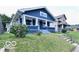 Charming blue two-story home with a welcoming front porch and well-maintained lawn at 36 N Ewing St, Indianapolis, IN 46201