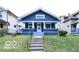 Charming blue craftsman-style home featuring a welcoming front porch and well-maintained lawn at 36 N Ewing St, Indianapolis, IN 46201