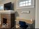 Well-lit living space with a brick fireplace and functional desk area at 36 N Ewing St, Indianapolis, IN 46201