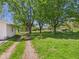 The backyard features a long gravel driveway leading to a large grassy area and a storage shed at 3631 Columbus Ave, Anderson, IN 46013