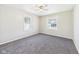 This bedroom has neutral walls, carpet flooring and natural light from the two windows and a ceiling fan at 3631 Columbus Ave, Anderson, IN 46013