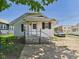 Charming single-story home with a covered porch, steps leading to the front door and nice landscaping at 3631 Columbus Ave, Anderson, IN 46013