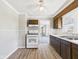 Functional kitchen with wood cabinets, vinyl flooring, and a white gas range at 3631 Columbus Ave, Anderson, IN 46013