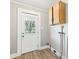 The mud room has wood-look flooring, exterior door and a wall cabinet for extra storage at 3631 Columbus Ave, Anderson, IN 46013