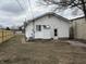 View of home's backyard with new fence and exterior door at 3720 W 16Th St, Indianapolis, IN 46222
