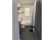 Renovated bathroom features a sleek, modern design with black hexagon flooring and a white tiled shower at 3720 W 16Th St, Indianapolis, IN 46222