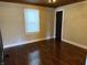 Bright bedroom with dark hardwood floors, neutral paint, and a classic wood ceiling and trim at 3720 W 16Th St, Indianapolis, IN 46222