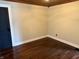 Cozy bedroom featuring gleaming hardwood floors, updated baseboards, and fresh paint at 3720 W 16Th St, Indianapolis, IN 46222