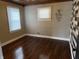 Sunlit bedroom with gleaming hardwood floors, fresh paint, new light fixture, and updated trim at 3720 W 16Th St, Indianapolis, IN 46222