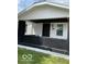 Charming home exterior featuring a quaint front porch with black brick and a freshly painted entrance at 3720 W 16Th St, Indianapolis, IN 46222