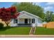 Charming single-story home with white siding, black shutters, green lawn, and a red maple tree in the front yard at 3720 W 16Th St, Indianapolis, IN 46222