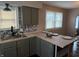 Bright kitchen has updated cabinets, and countertop with stylish backsplash at 3720 W 16Th St, Indianapolis, IN 46222