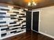 A modern living room featuring hardwood floors, unique wood accent wall, and modern ceiling fan light at 3720 W 16Th St, Indianapolis, IN 46222