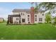 Beautiful backyard with a patio, manicured lawn and a pergola for outdoor dining at 3743 Earhart Dr, Carmel, IN 46074