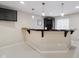 Finished basement bar area with custom cabinets, sink and bar top with pendant lights at 3743 Earhart Dr, Carmel, IN 46074