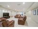 Finished basement featuring neutral walls, leather furniture, and a workout area at 3743 Earhart Dr, Carmel, IN 46074