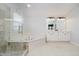 Bright bathroom features a soaking tub, glass enclosed shower, and double sink vanity at 3743 Earhart Dr, Carmel, IN 46074