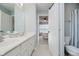 Bright bathroom featuring double sinks with a view into the bedroom at 3743 Earhart Dr, Carmel, IN 46074