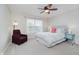 Cozy bedroom featuring a comfy chair, large window, queen bed and two side tables at 3743 Earhart Dr, Carmel, IN 46074