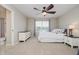 Neutral bedroom featuring ceiling fan, dresser, view of bathroom, and plenty of natural light at 3743 Earhart Dr, Carmel, IN 46074
