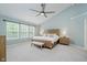 Serene main bedroom features a vaulted ceiling, ceiling fan, and a wooden bed frame at 3743 Earhart Dr, Carmel, IN 46074