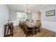 Formal dining room featuring a long wooden table, a chandelier, and large windows at 3743 Earhart Dr, Carmel, IN 46074
