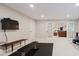 Finished basement offers an exercise room, featuring black gym flooring and french doors at 3743 Earhart Dr, Carmel, IN 46074