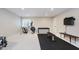 Finished basement offers an exercise room with an elliptical machine and weight training equipment at 3743 Earhart Dr, Carmel, IN 46074