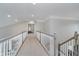 Bright and airy hallway with neutral carpet, white railings, and ample natural light at 3743 Earhart Dr, Carmel, IN 46074
