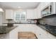 Modern kitchen featuring granite counters, stainless steel appliances, and ample cabinet space at 3743 Earhart Dr, Carmel, IN 46074