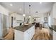 Open kitchen with granite island, stainless appliances and view to dining and living areas at 3743 Earhart Dr, Carmel, IN 46074