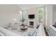 Bright living room featuring a fireplace, large windows, and vaulted ceilings at 3743 Earhart Dr, Carmel, IN 46074