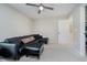 Spacious living room with a black sectional sofa, view of closet, neutral walls and carpet at 3743 Earhart Dr, Carmel, IN 46074
