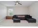 Spacious living room with a black sectional sofa, window with blinds, and beige carpet at 3743 Earhart Dr, Carmel, IN 46074