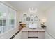 Bright home office with a large window and a decorative chandelier at 3743 Earhart Dr, Carmel, IN 46074