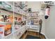 Well-organized walk-in pantry with shelves stocked with a variety of food and household items at 3743 Earhart Dr, Carmel, IN 46074