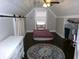 Attic bedroom with exposed ceiling beams, a cozy bed, and natural light from the window at , Plainfield, IN 46168