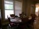 Sunlit dining area with an oval table, seating for six, and large window at , Plainfield, IN 46168