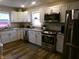 Modern kitchen with white cabinets, granite countertops, and stainless steel appliances at , Plainfield, IN 46168