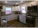 Modern kitchen with white cabinets, granite countertops, and stainless steel appliances at , Plainfield, IN 46168